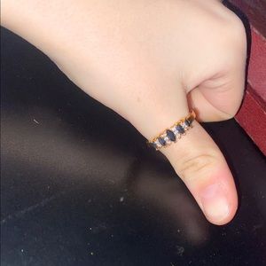 Woman’s elegant gold banded ring with diamond obsidian stones